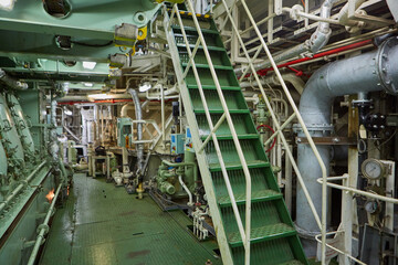 Ship's engine room. Vessel's ( Ship ) Engine Room Space / industrial stairs. Ship's Engine Heavy Machinery Space - Pipes, Valves, Engines