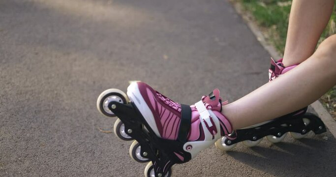 View of exposed female legs wearing rollerblades