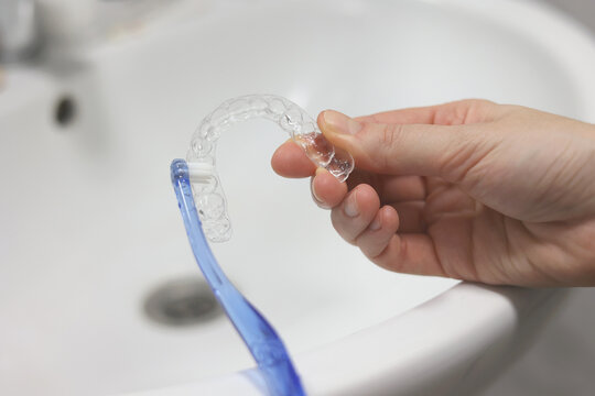 cleaning aligners to straighten teeth.