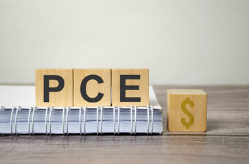 pce text from wooden blocks on a grey wooden background
