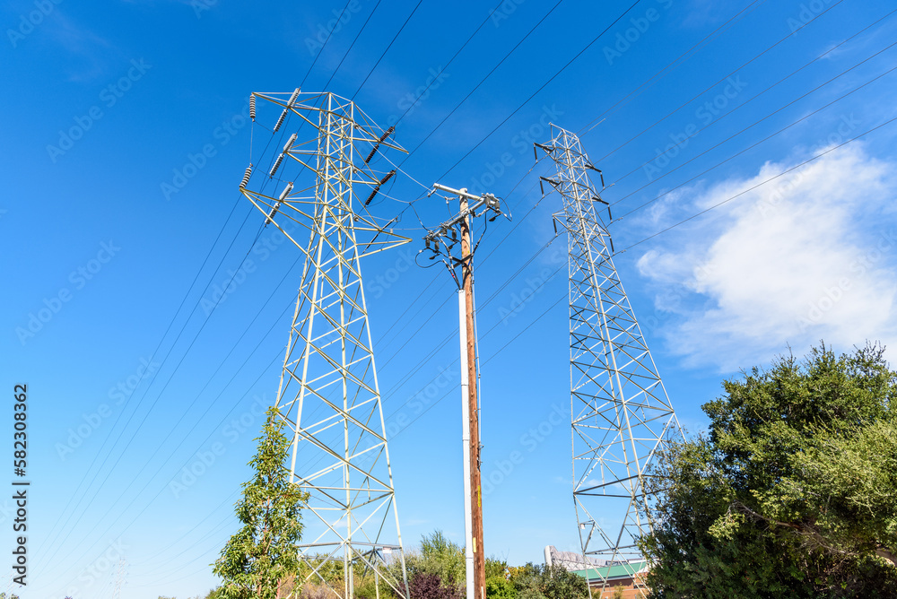 Wall mural tall pylons supporting high voltage lines on a clear autumn day