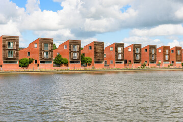 Row of modern detached houses in a housing development on a cloudy summer day