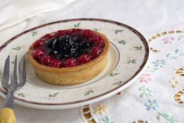 a delicious tart with berries and custard