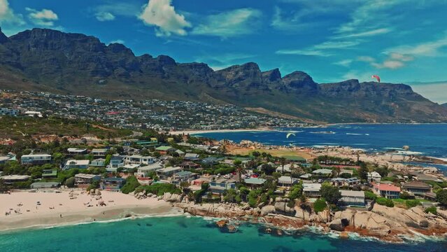 Aerial view of the twelve apostoles over Camps Bay beach with paratroopers in Cape Town South Africa.