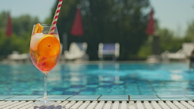 Cold and refreshing aperol spritz cocktail is the perfect summer drink at poolside.