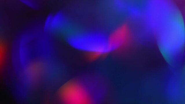 Neon Bokeh Circular Motion Abstract Background. Movement of defocused circles in blue, purple, red and green colors. Glowing vibrant bokeh lights in a 4K moving background.