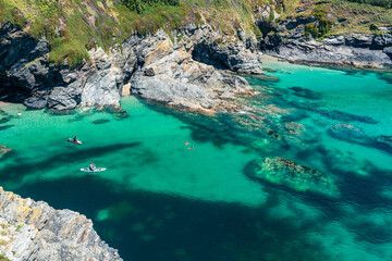 People on padelboards, Piskies Cove, South West Coast Path, Penzance, Cornwall, England