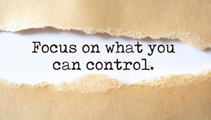 Focus on what you can control. Words written under torn paper. Motivation concept text.