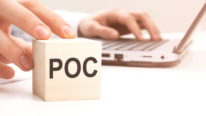 POC text wooden block on white table background. Idea, strategy, advertising, marketing, keyword...