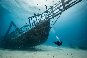 Woman diver explores the wreck of the JabJab on the Bridge divesite off the Dutch Caribbean island of Sint Maarten