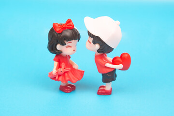 miniature people. figures for the game. romantic couple of young people. A boy lovingly gives his heart to a cute girl