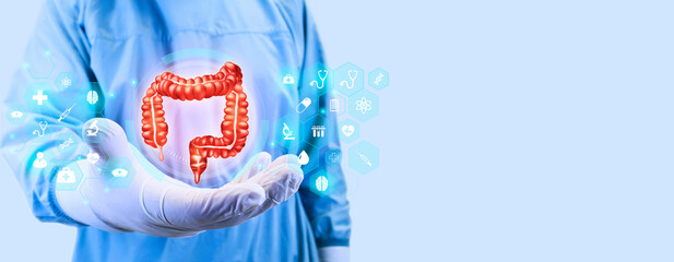Surgeon hand hold a digital large intestine on light blue background. Colon cancer, bacteria, virus...