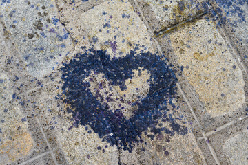 A heart drawn with wax on the road.