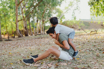 Dad and son play at the park