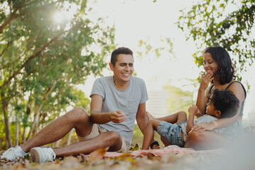 Family enjoying together having a picnic at the park