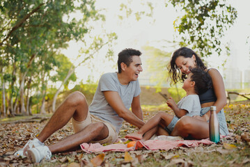 Family enjoying together having a picnic at the park