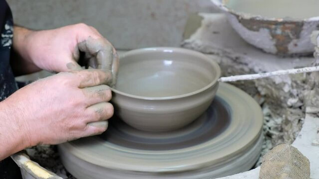 Video of potter’s hands making the clay bowl on the potter's wheel. Crete