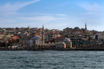 Fototapeta premium Uskyudar district in the Asian part of Istanbul and the Shemsi Ahmed Pasha Mosque from the Bosporus water area on a sunny day, Istanbul, Turkey