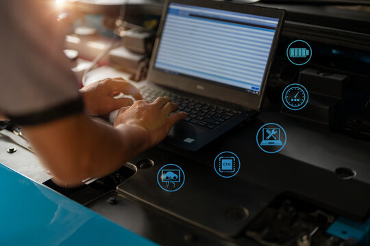 Asian engineer or technician maintenance technician EV car Engineer use augmented reality software to monitor parts of car vehicle with automated applicatio