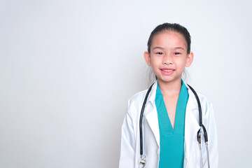 Fototapeta premium Asian child Wearing a doctor's suit and having a stethoscope