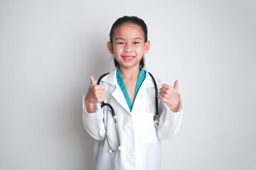 Fototapeta premium Asian child Wearing a doctor's suit and having a stethoscope