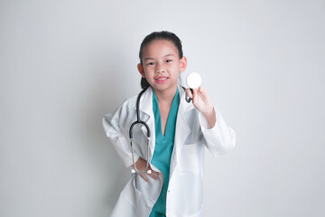 Asian child Wearing a doctor's suit and having a stethoscope