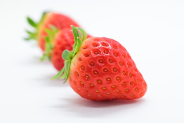 beautiful three fresh red strawberry isolated on white background