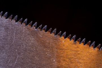 Hacksaw blade with sharp teeth close-up.