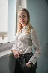 Portrait of a young beautiful blonde girl in an interior studio.