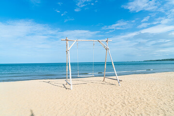 Obraz na płótnie Canvas wooden swing on the beach