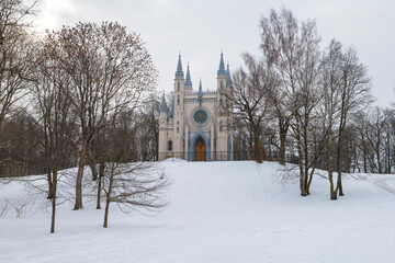Ancient chapel of the holy prince Alexander Nevsky in a winter landscape on a cloudy February day....
