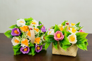 Bouquets fragrant crocuses of daffodils from handmade soap in baskets on a white background.