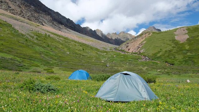 Tourist tent camp in Altai highlands near river Yarlyamry. Kuray mountain range in Altai.