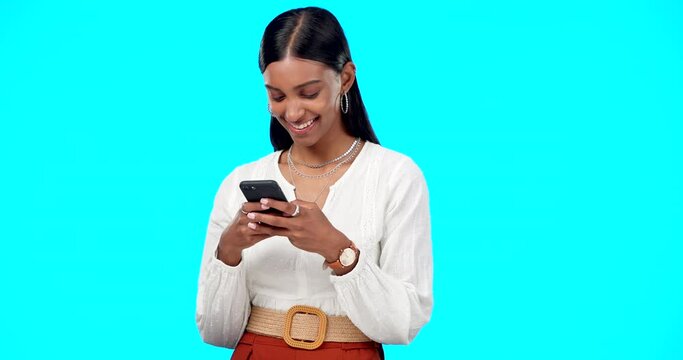 Woman laughing, typing and phone isolated on blue background for social media post, network and web chat. Happy indian person or online user with mobile app, smartphone or meme in studio mockup