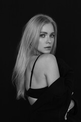 Naklejka premium portrait of a blonde on a black background