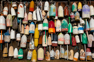 Buoys on wall in Maine.