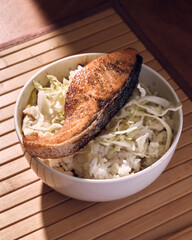 Japanese bowl of rice and salmon with chopsticks
