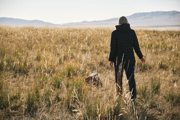 Girl traveler walks through the area near the lake TuzKol