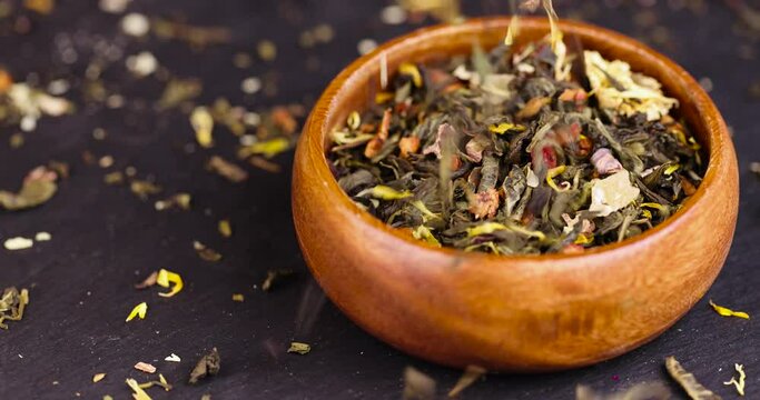 A large amount of dry green tea with pieces of fruit, delicious and fragrant green tea with a pleasant aroma