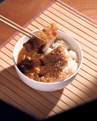 customer eating Japanese curry with chopsticks