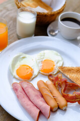 American breakfast with eggs, bacon,milk, coffee and orange juice