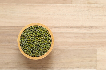 Top view of green beans in a bowl on wooder background, Healthy eating concept