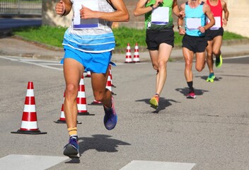 runners during the marathon on the city streets run in sneakers