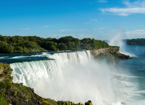 Scenic view of Niagara Falls on sunny day