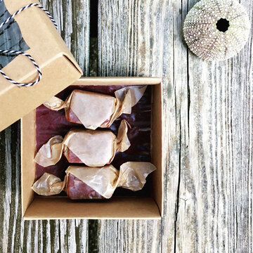 High angle view of candies in box by sea urchin on jetty