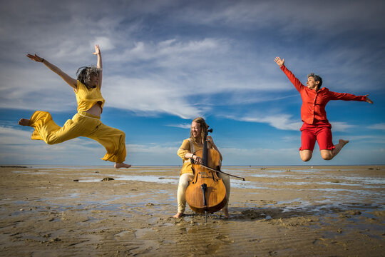 dancers and cellist performing on Cape Cod beach