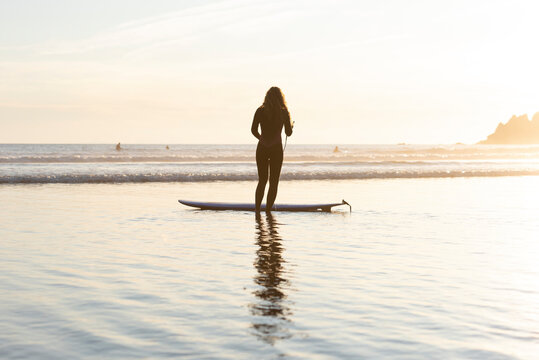 Surfer getting ready to head out into the surf