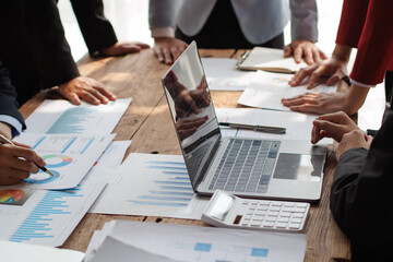 Teamwork with businessman analyzing cost graphs on table at conference room.