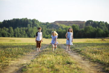 Fototapeta premium Children walk in the summer in nature. Child on a sunny spring morning in the park. Traveling with children.