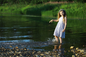 Fototapeta premium Children walk in the summer in nature. Child on a sunny spring morning in the park. Traveling with children.